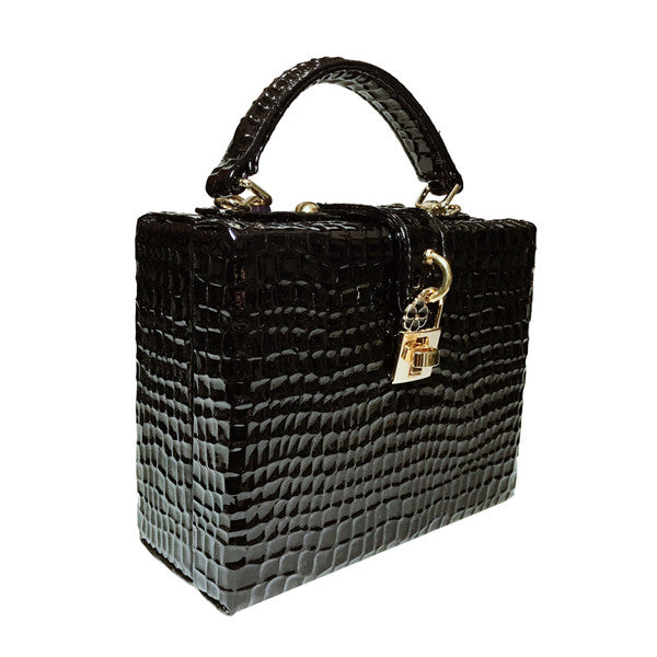 Black textured handbag with gold accents on a white background