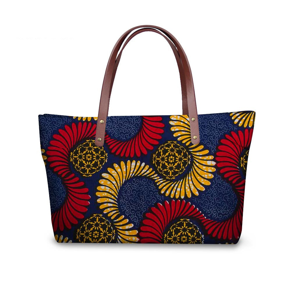 Colorful patterned handbag with brown handles on a white background