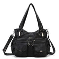 Black handbag with multiple pockets and straps on a white background