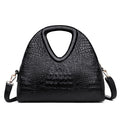 Black textured handbag with a shoulder strap on a white background
