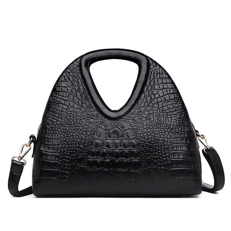 Black textured handbag with a shoulder strap on a white background