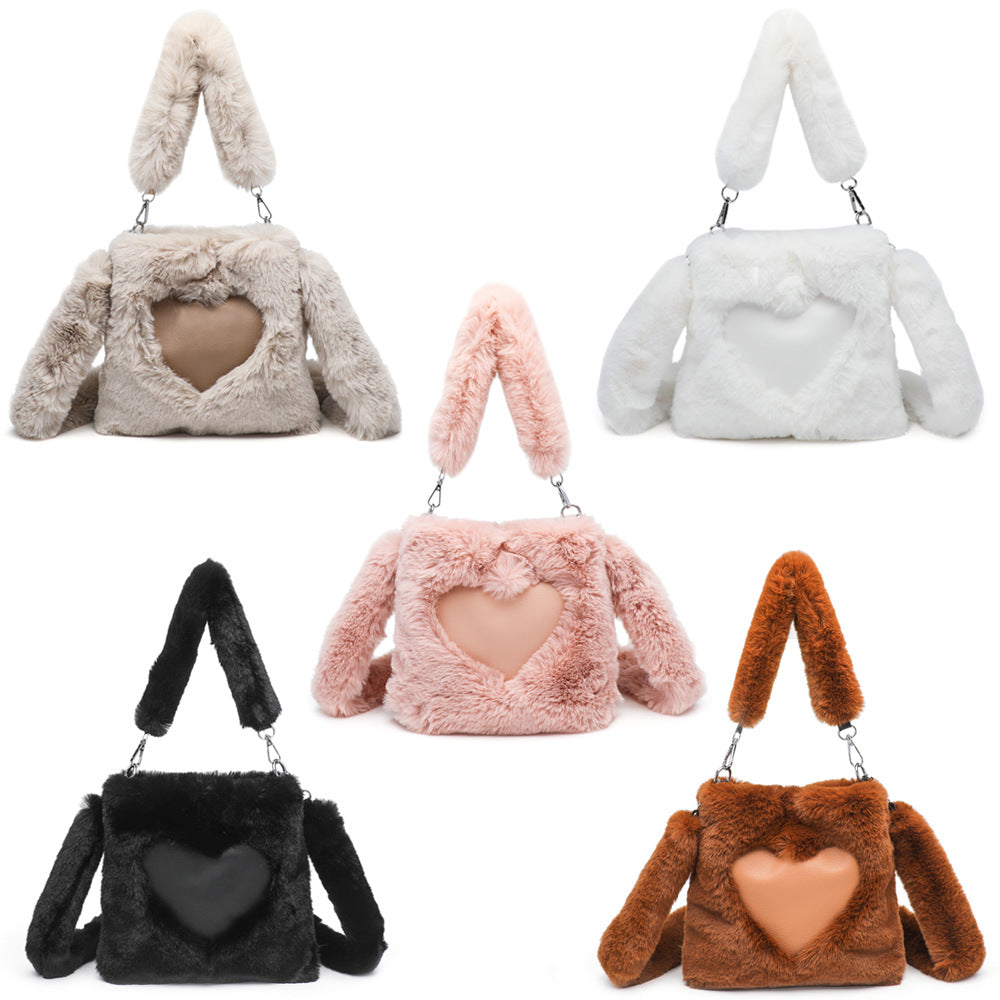 Five fluffy handbags with heart-shaped centers in various colors on a white background.