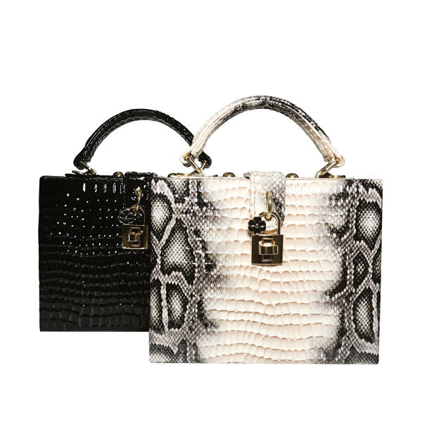 Two handbags, one black and one with snake skin pattern, on a white background.