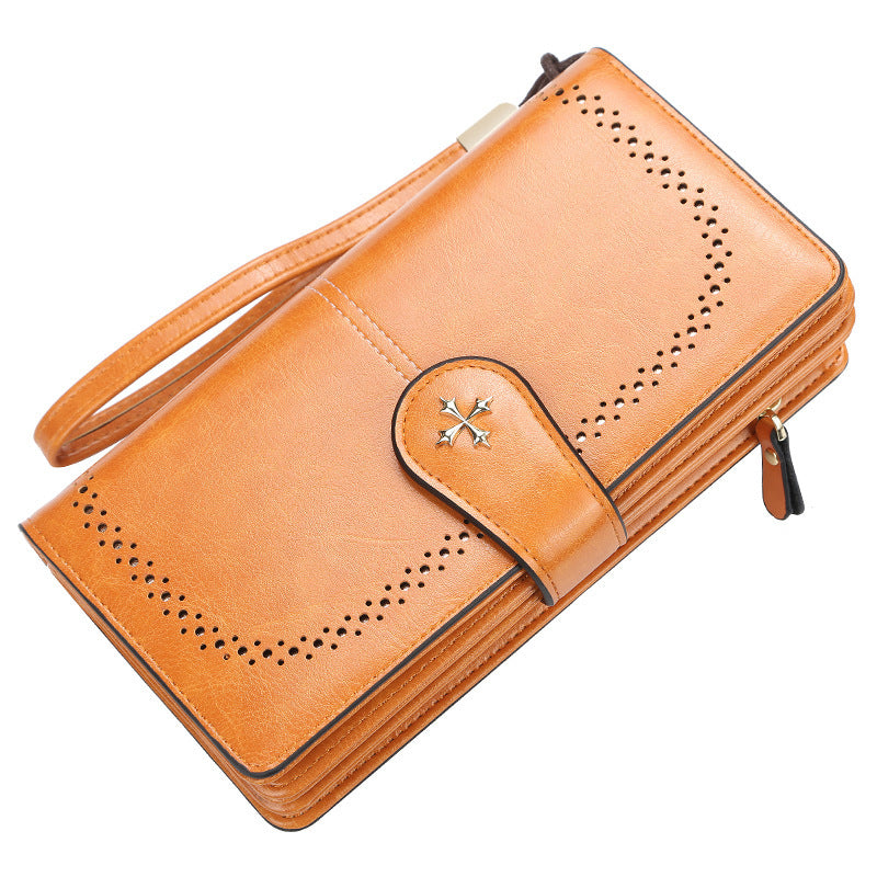 Brown leather wallet with perforated design on a white background