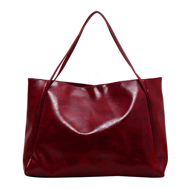 Red leather tote bag on a white background