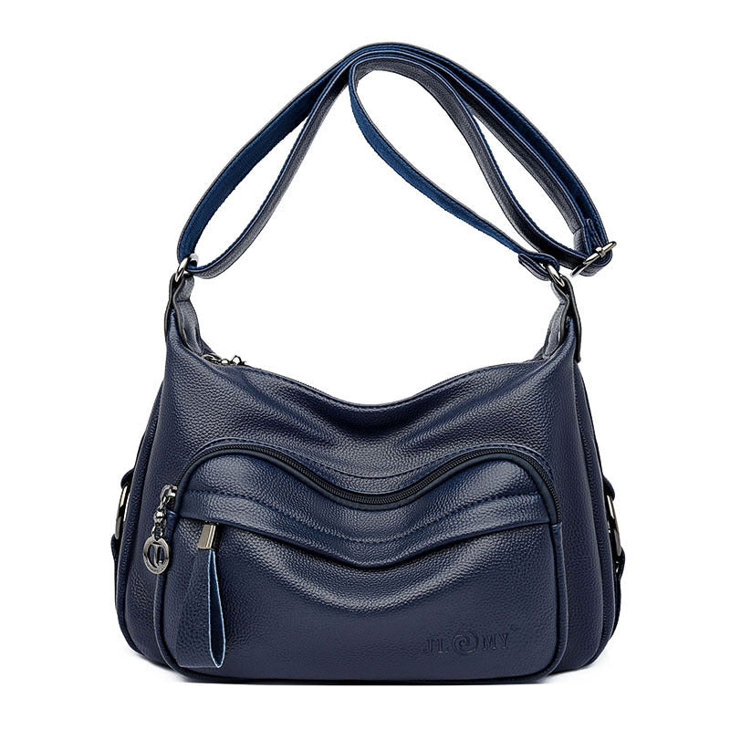 Navy blue handbag with a textured surface on a white background
