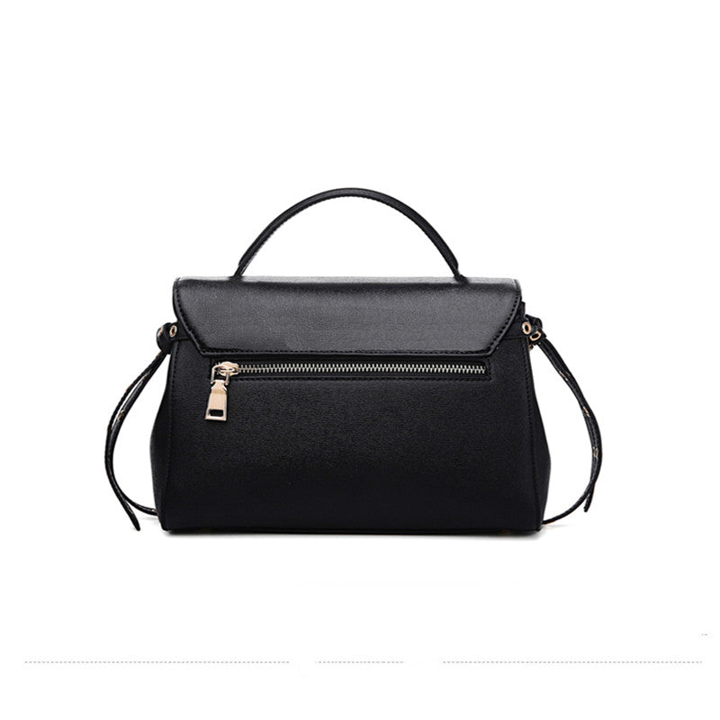 Black handbag with a strap on a white background
