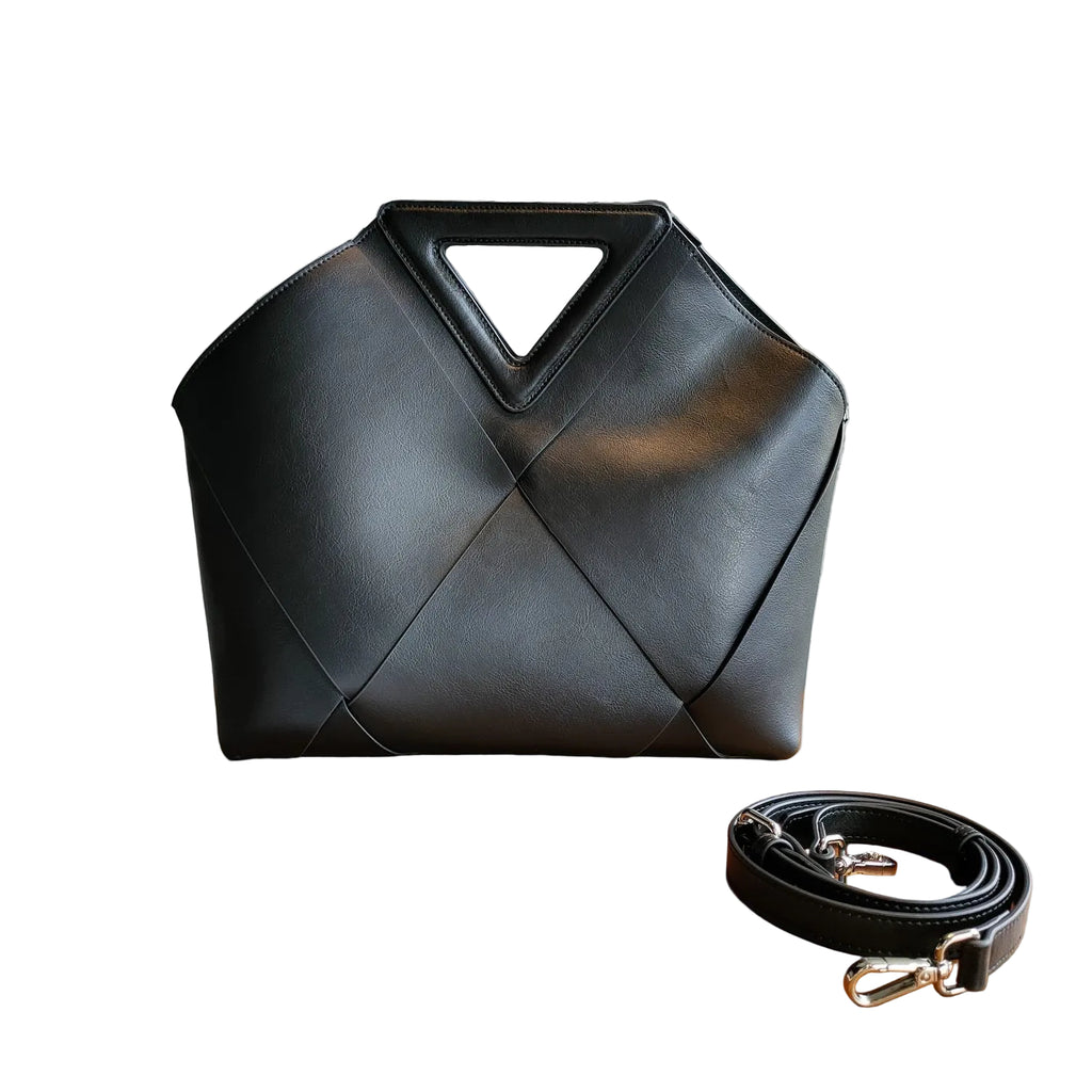 Black handbag with geometric design in a white background