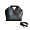 Black handbag with geometric design in a white background
