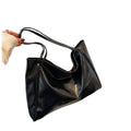 Black handbag on a black chair with on a white  background