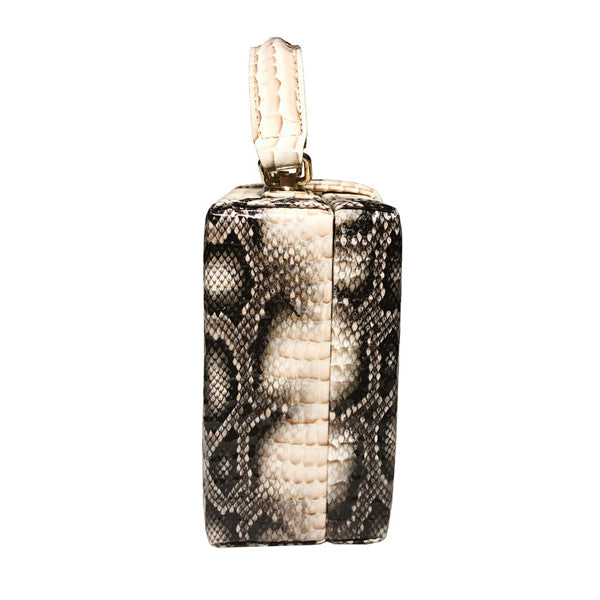 Gold pendant with snake skin pattern on a white background