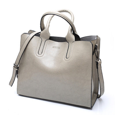 Gray handbag with a strap on a white background