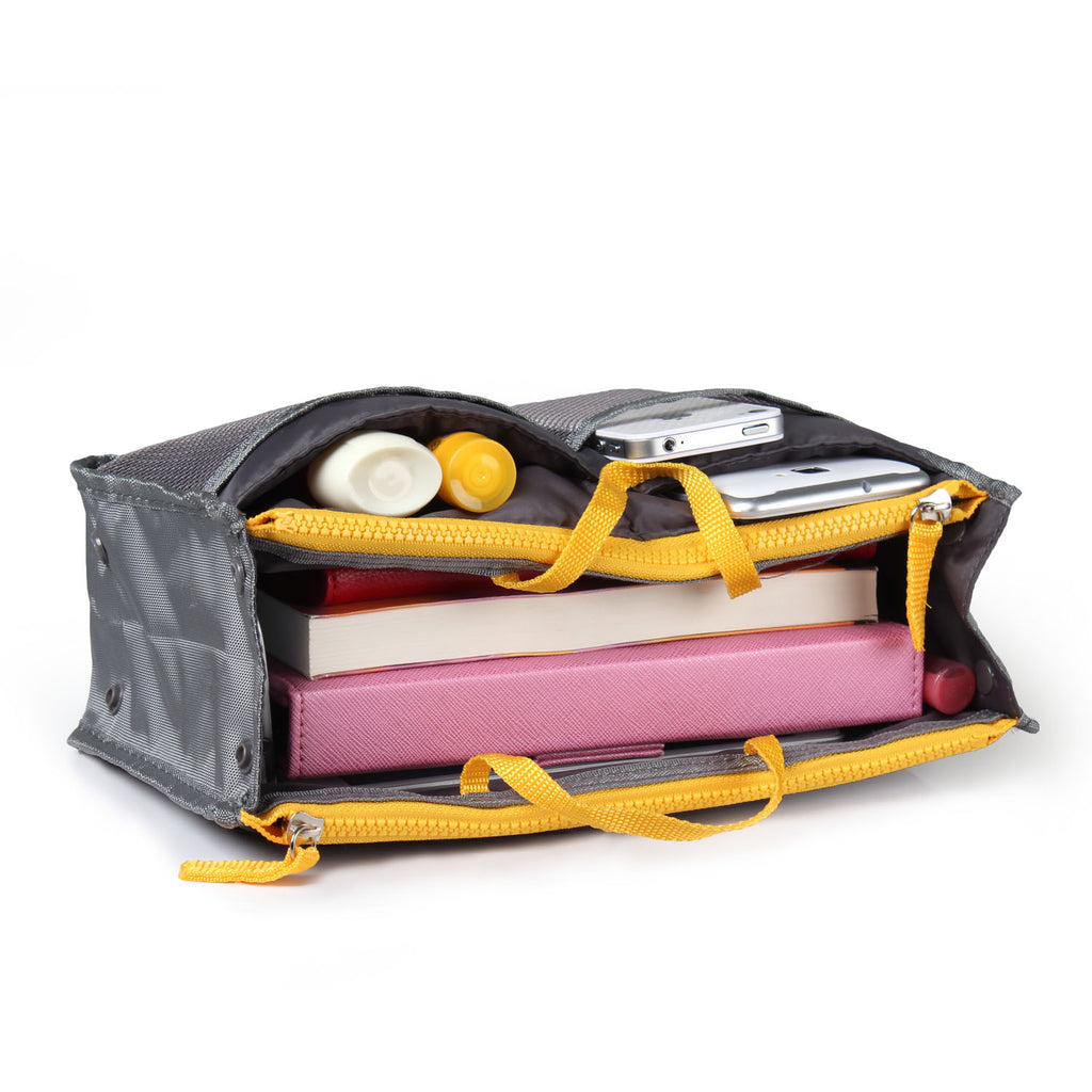 gray compartmentalized bag with electronic devices inside on a white background