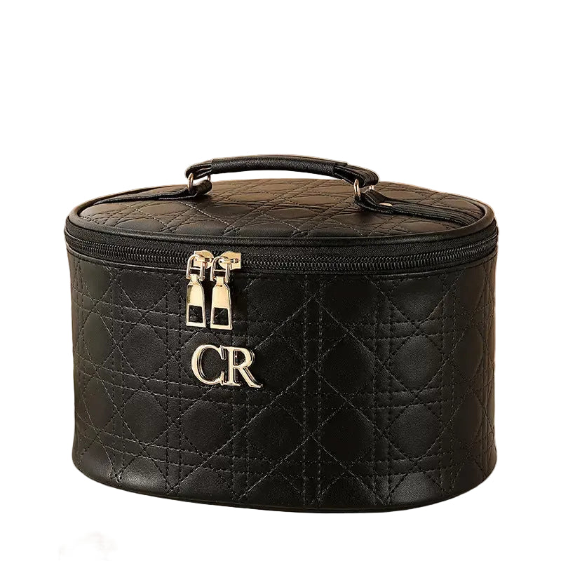 Black quilted makeup bag with 'CR' initials on a white background