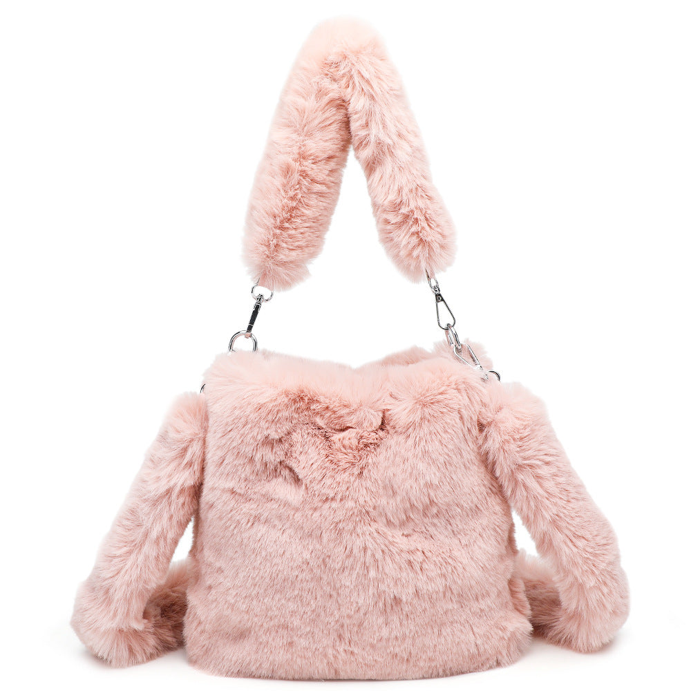 Pink fluffy handbag with bunny ears on a white background
