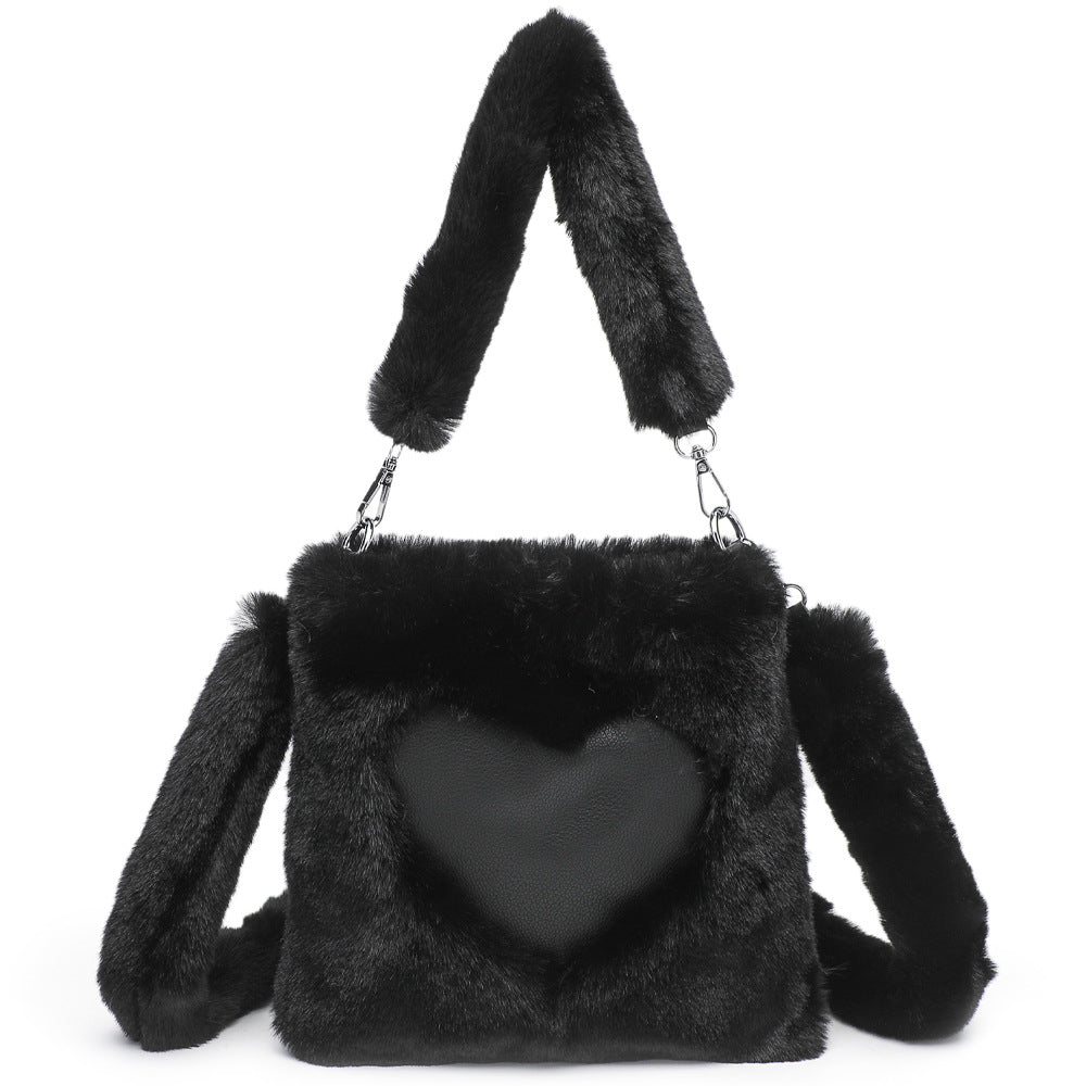 Black fluffy handbag with a heart-shaped front pocket on a white background