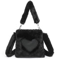 Black fluffy handbag with a heart-shaped front pocket on a white background