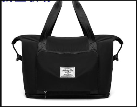 Black duffel bag with a visible brand label on a white background