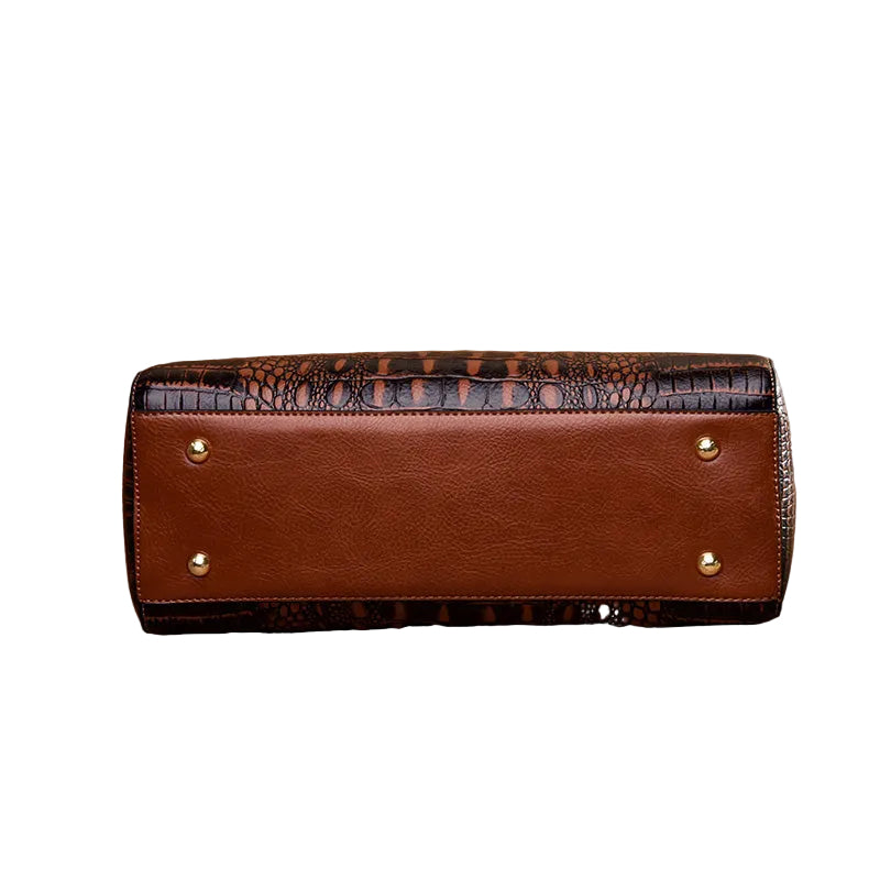Brown leather clutch with crocodile pattern on a white background