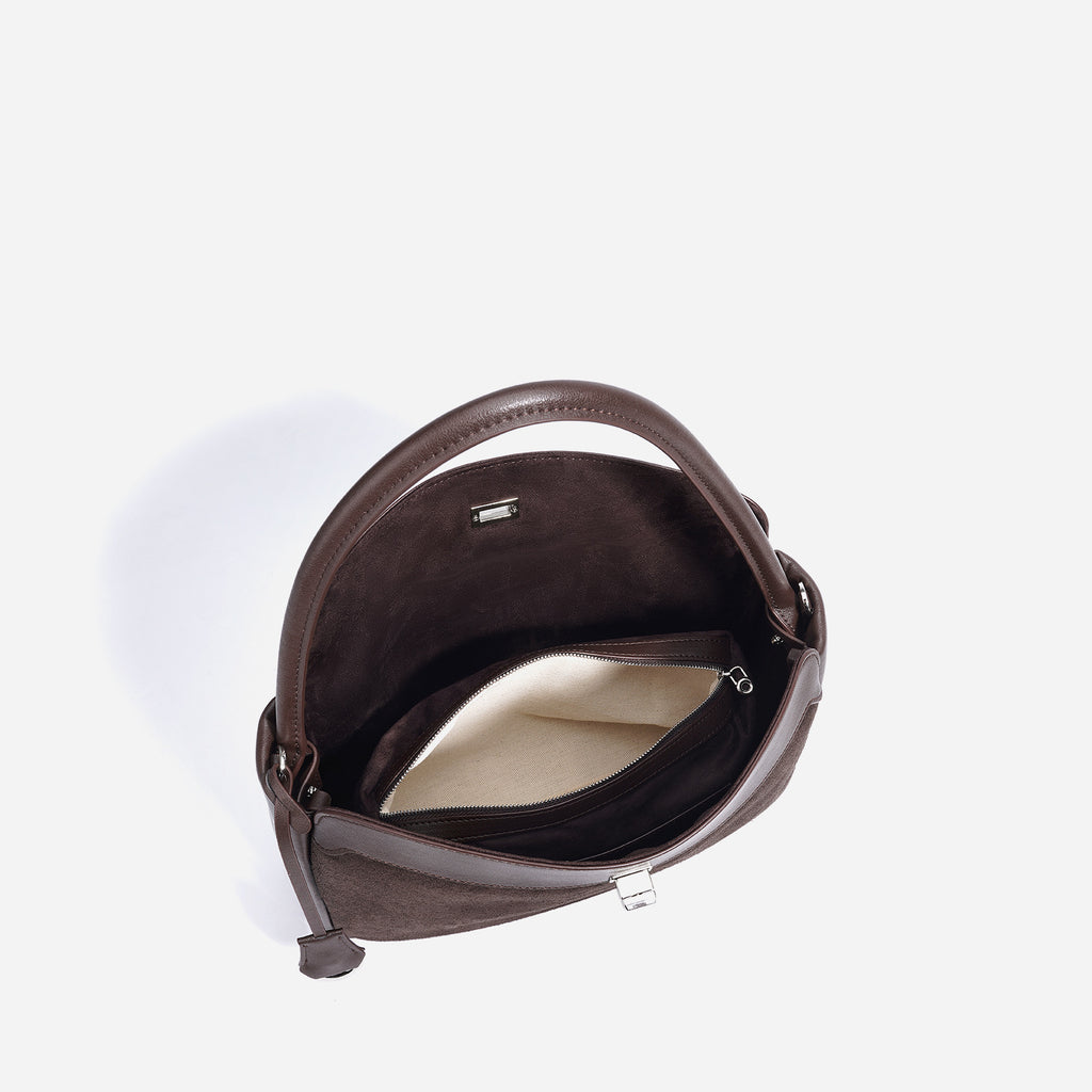 Brown leather handbag on a white background