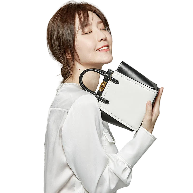 Woman holding a white handbag with a black handle against a white background