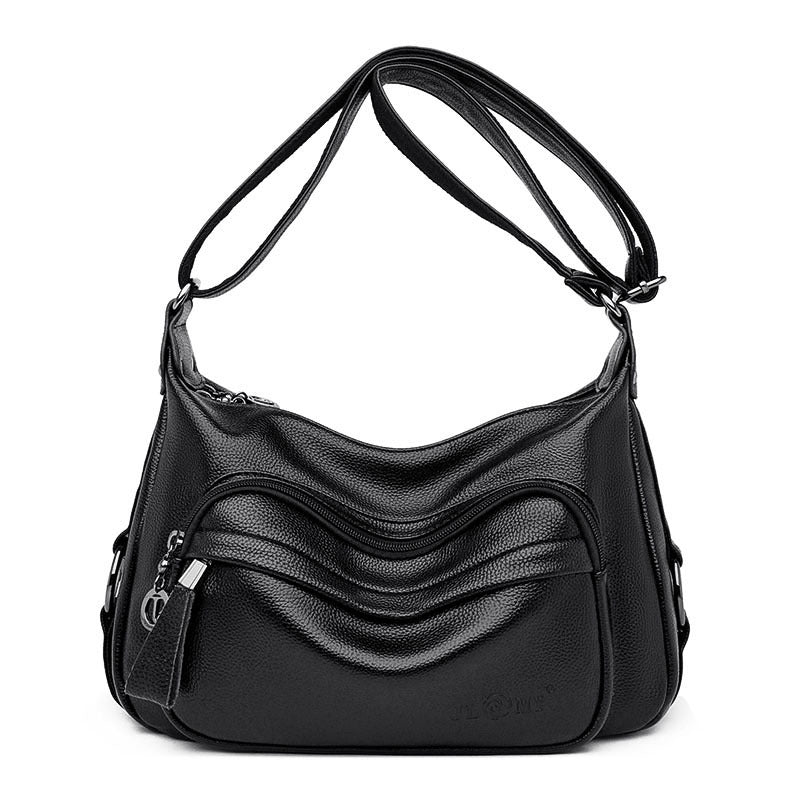 Black handbag with a textured surface on a white background