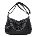 Black handbag with a textured surface on a white background