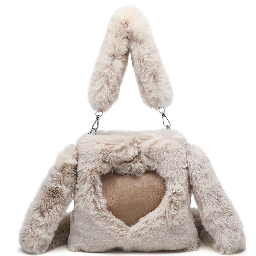 Fluffy beige handbag with bunny ears on a white background