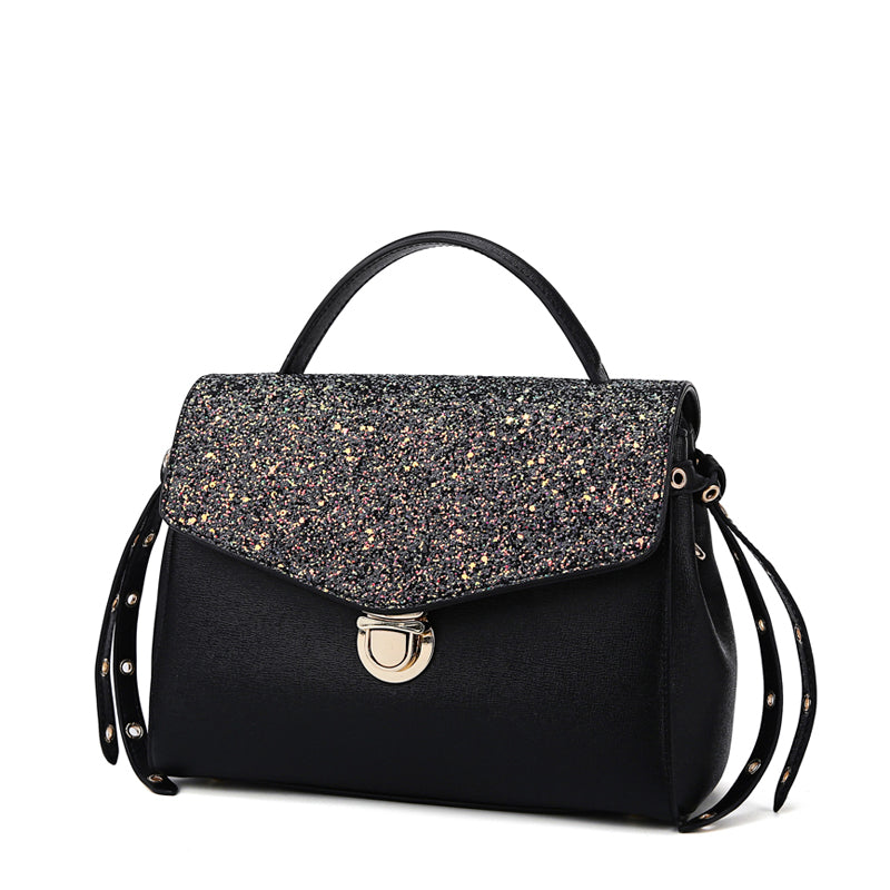 Black handbag with glittery flap on a white background