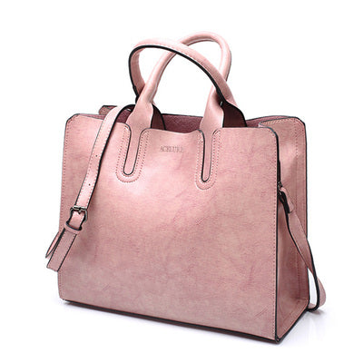 Pink handbag with a strap on a white background