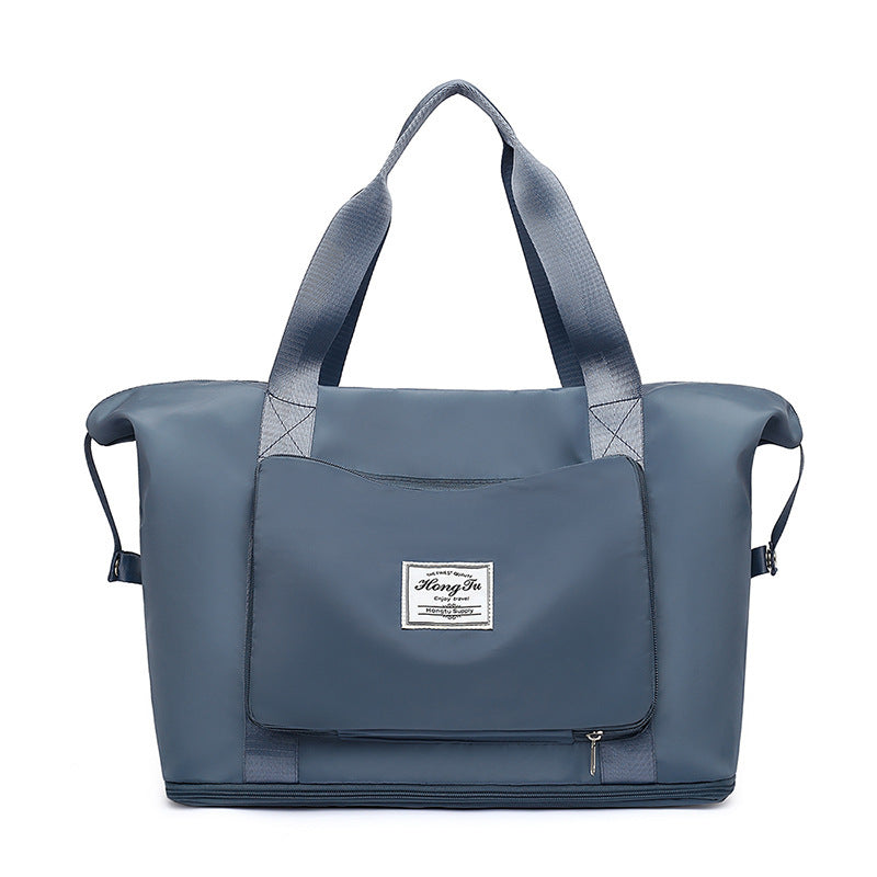 Blue tote bag with a visible brand label on a white background
