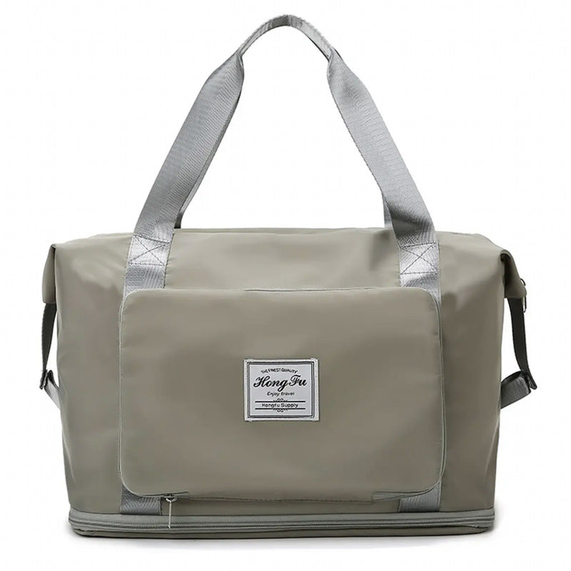 Gray duffel bag with a visible brand label on a white background