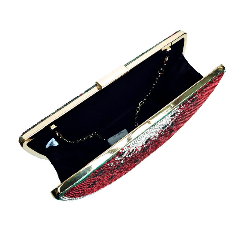 Red and gold clutch bag on a white background