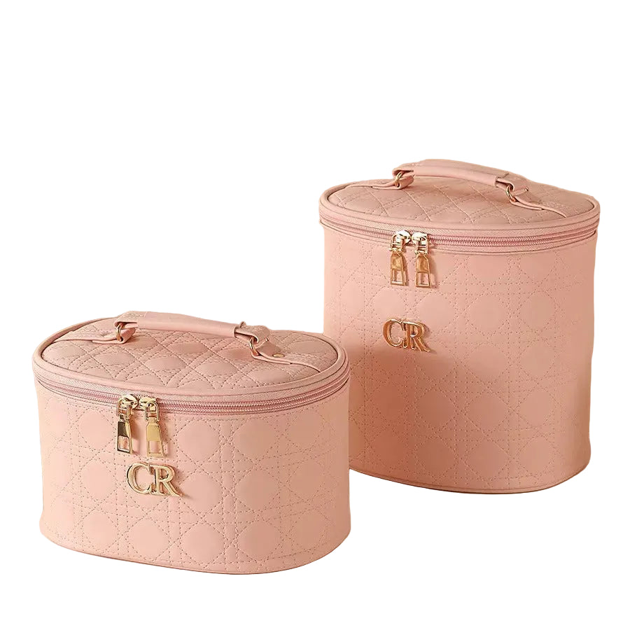 Two pink quilted cosmetic bags with gold accents on a white background.