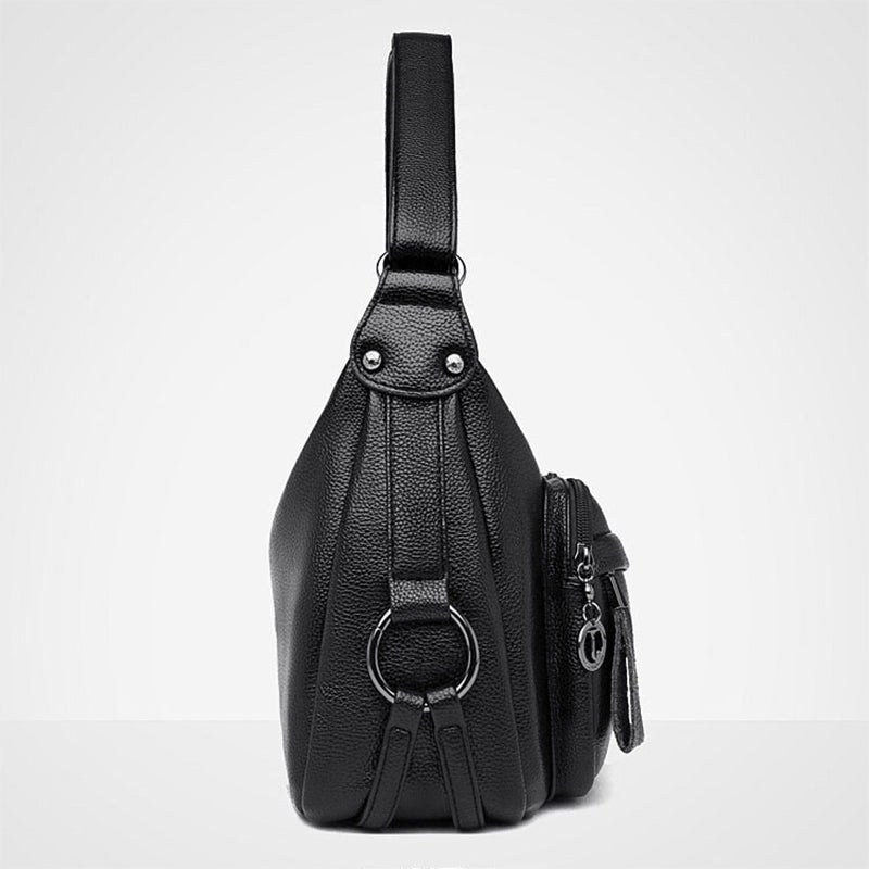 Black leather sling bag on a white background