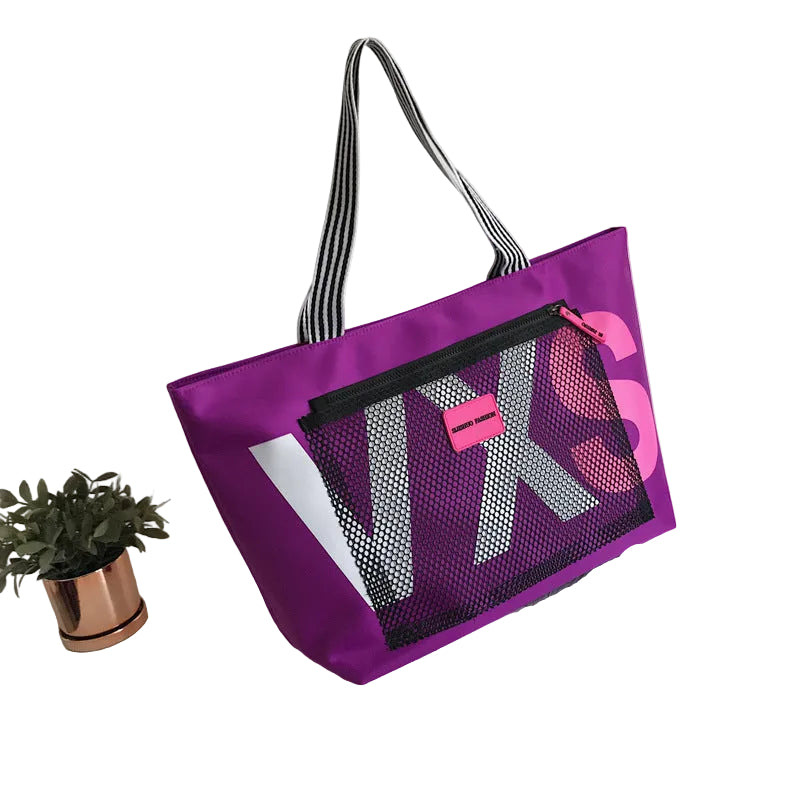 Purple tote bag with mesh pocket on a white background