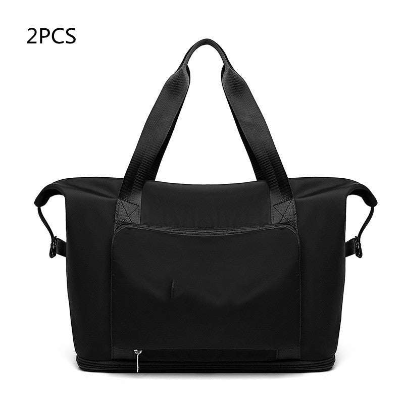 Black duffel bag with shoulder straps on a white background
