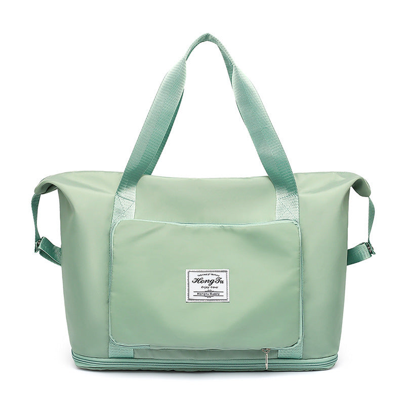 Mint green travel bag with a visible brand label on a white background