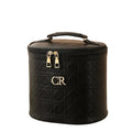 Black quilted makeup bag with gold accents on a white background