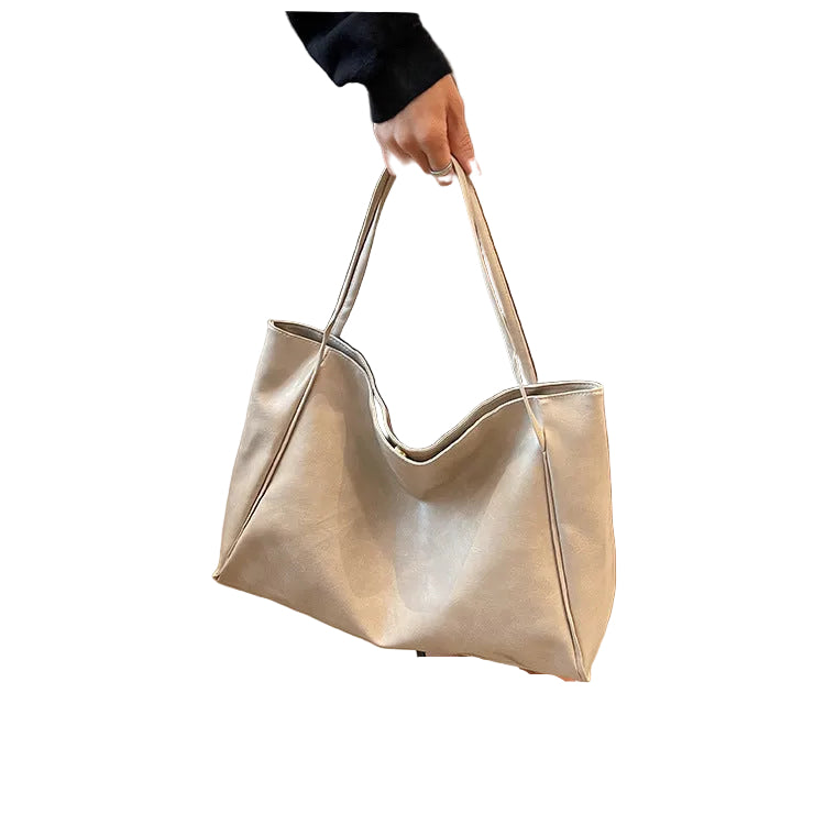 Person holding a silver handbag on a  white background