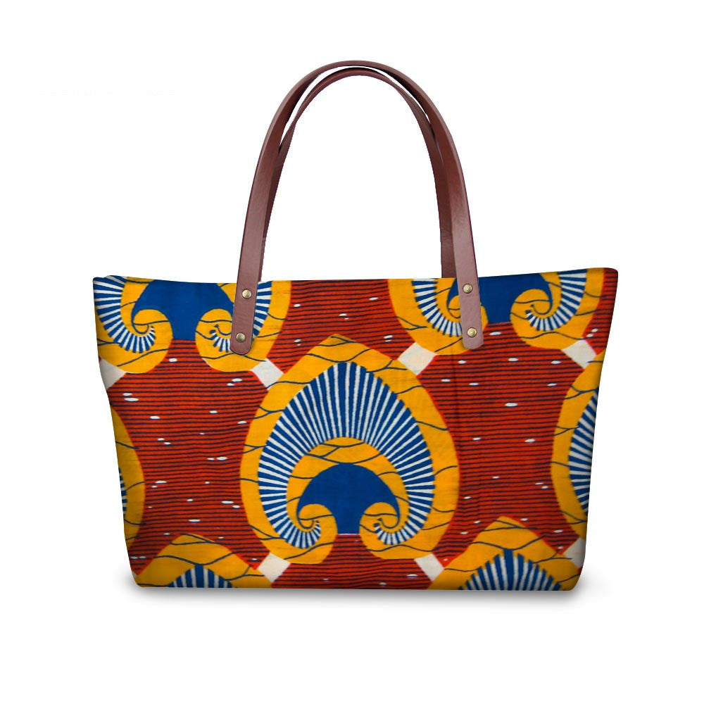Colorful patterned tote bag with brown handles on a white background