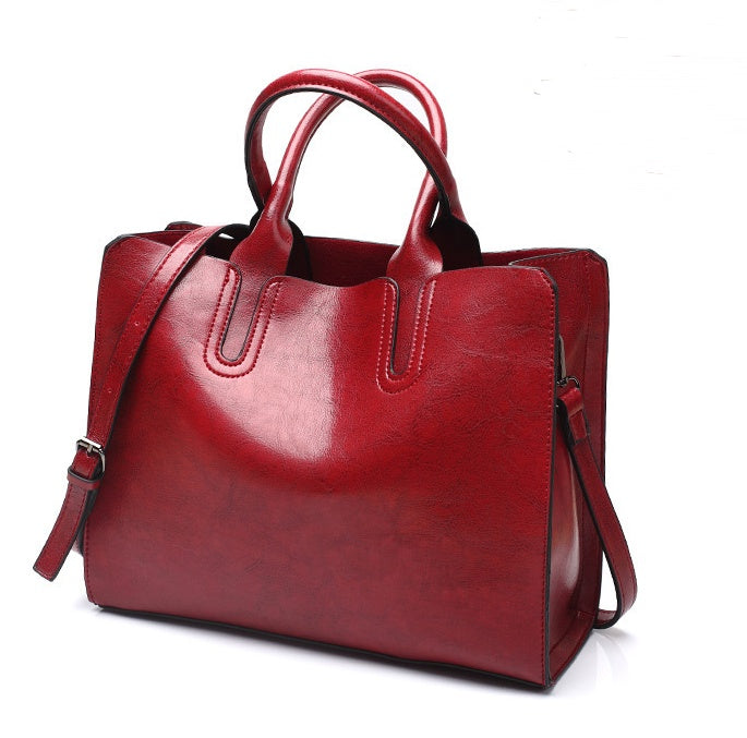 Red leather handbag on a white background