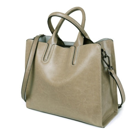 Beige handbag with a shoulder strap on a white background
