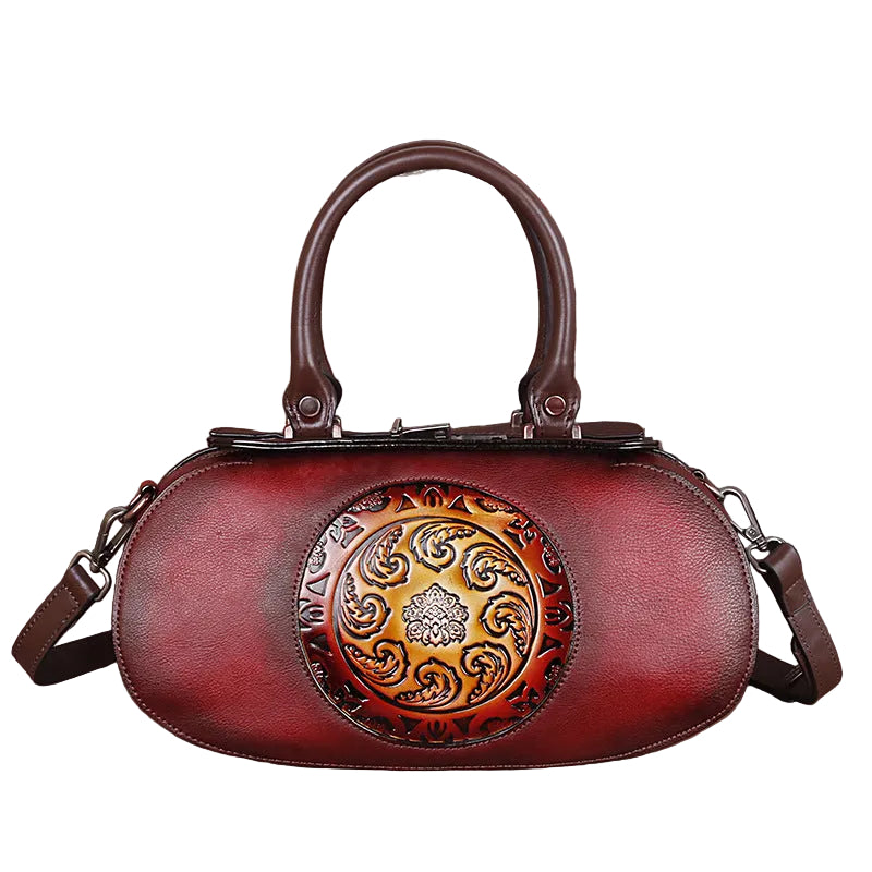 Red handbag with decorative emblem on a white background