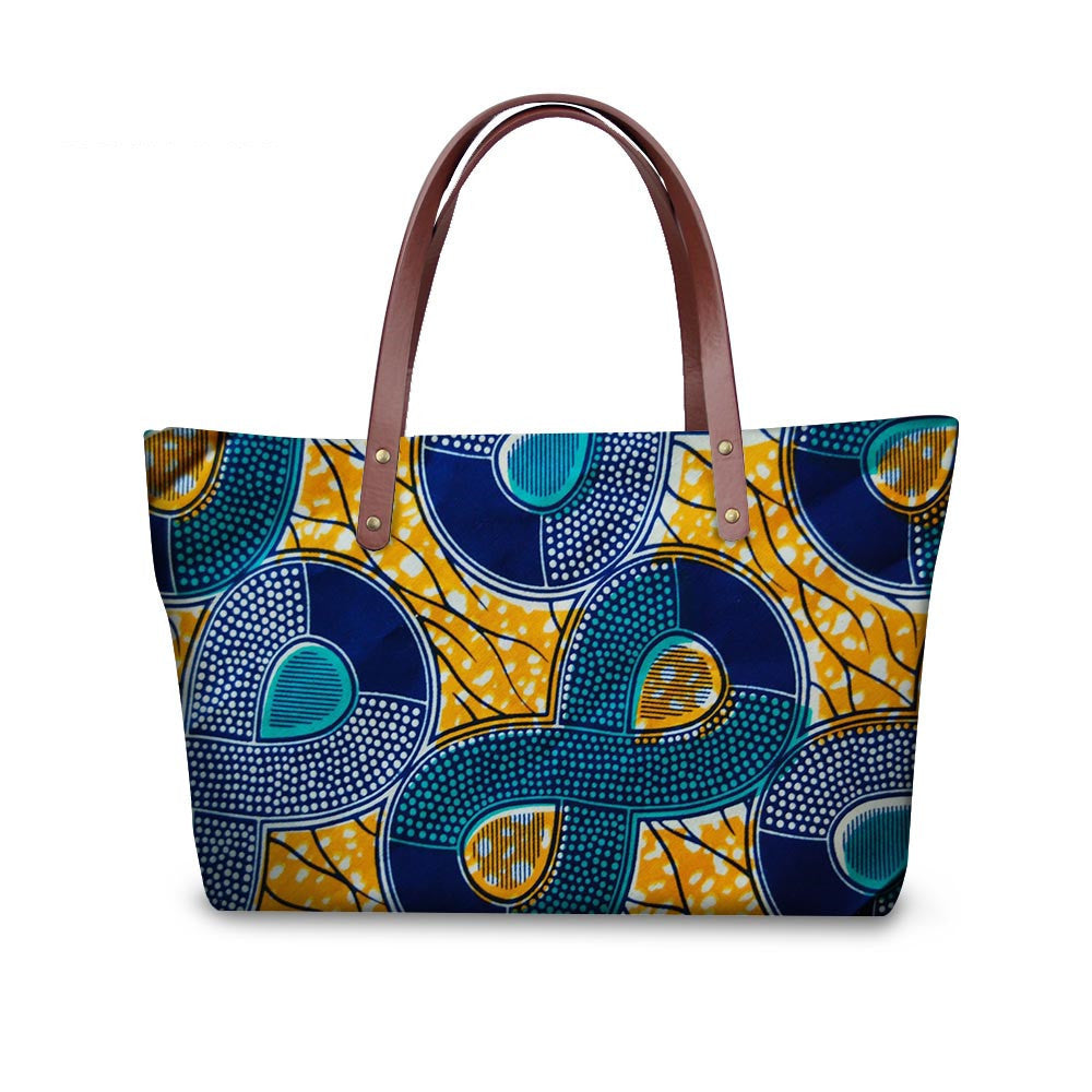 Colorful patterned handbag with brown handles on a white background