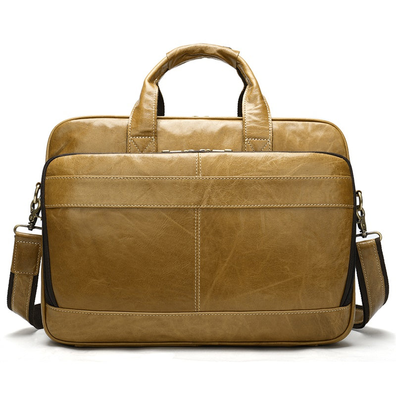 Brown leather briefcase with shoulder strap on a white background