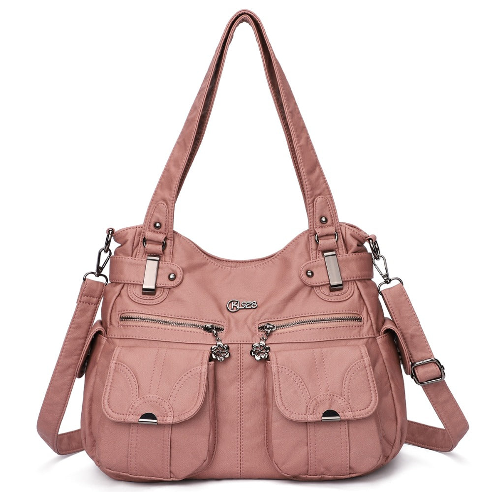 Pink handbag with multiple pockets and straps on a white background