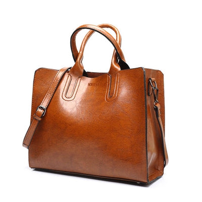 Brown leather handbag on a white background