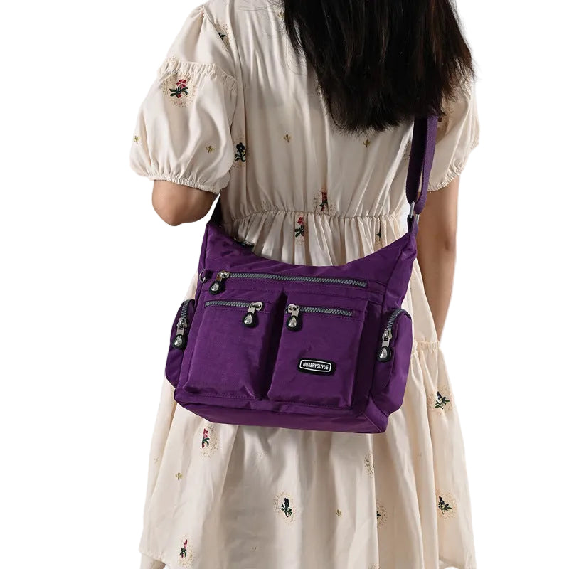 Person wearing a purple backpack with a white background