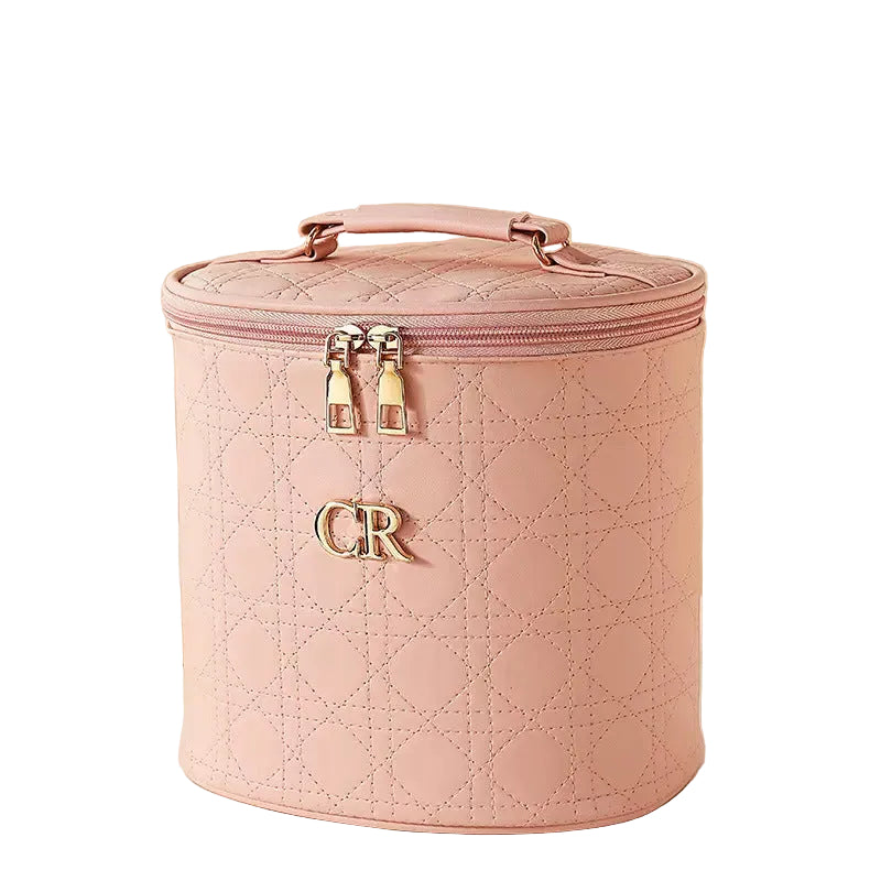 Pink quilted makeup bag with 'CR' initials on a white background